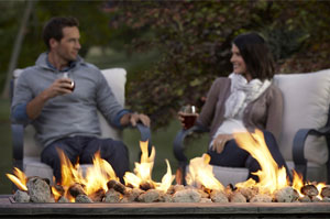 Couple Sitting by Fire Pit Drinking Wine
